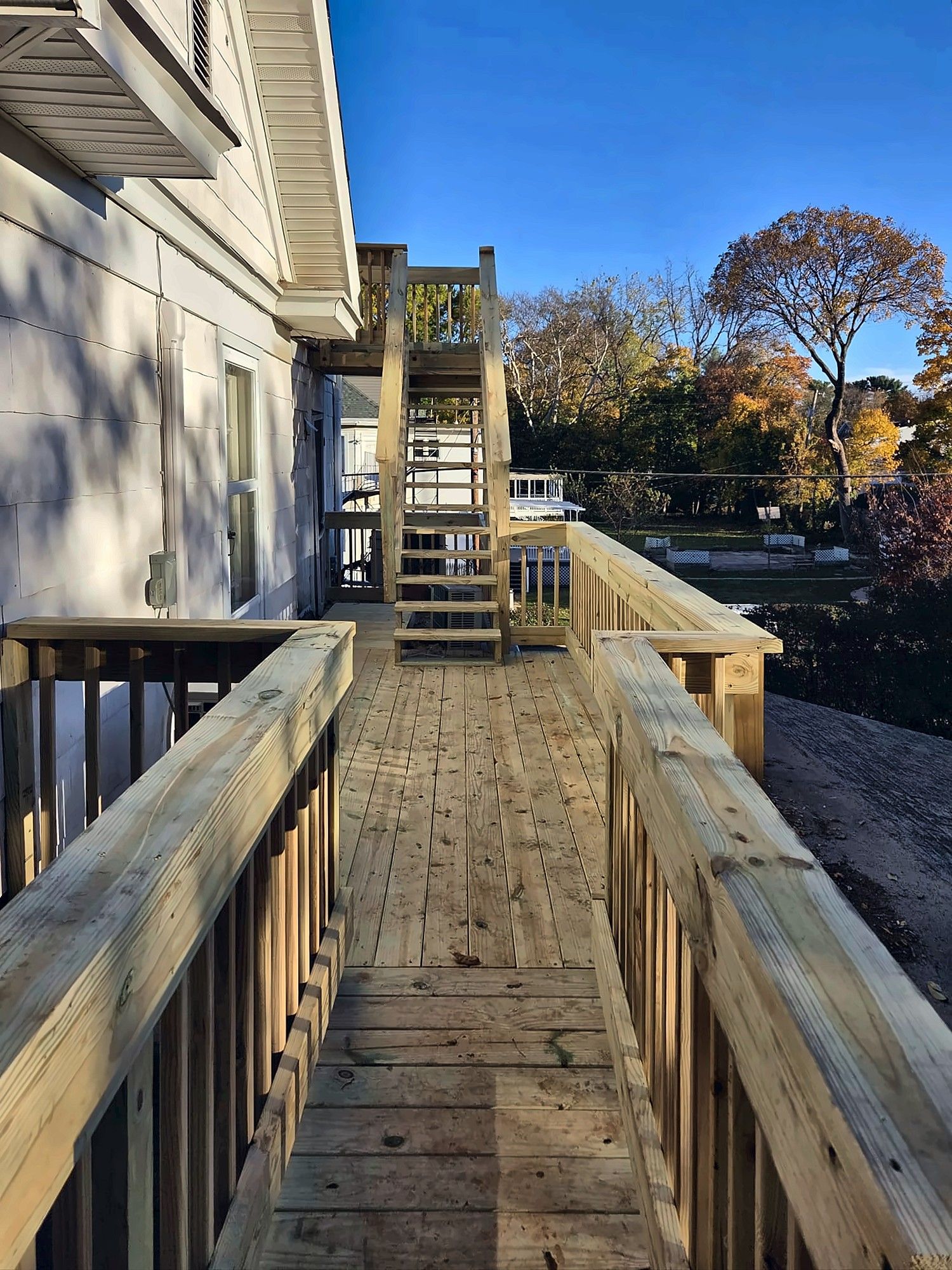 Wood deck walkway leading to exterior stairs