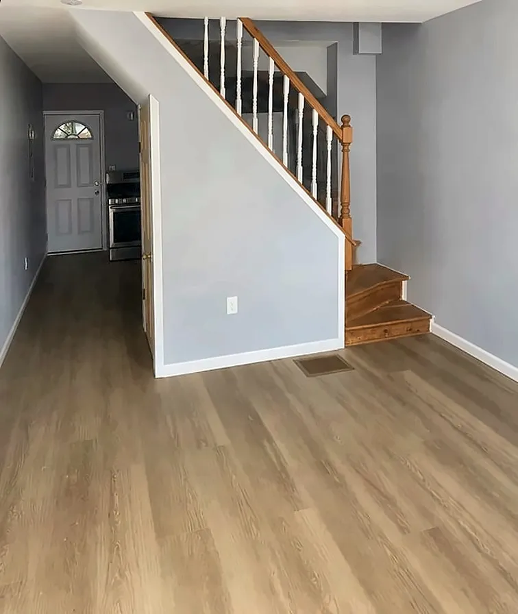 After: Before and after of a gutted stairwell turned into a finished entry hall